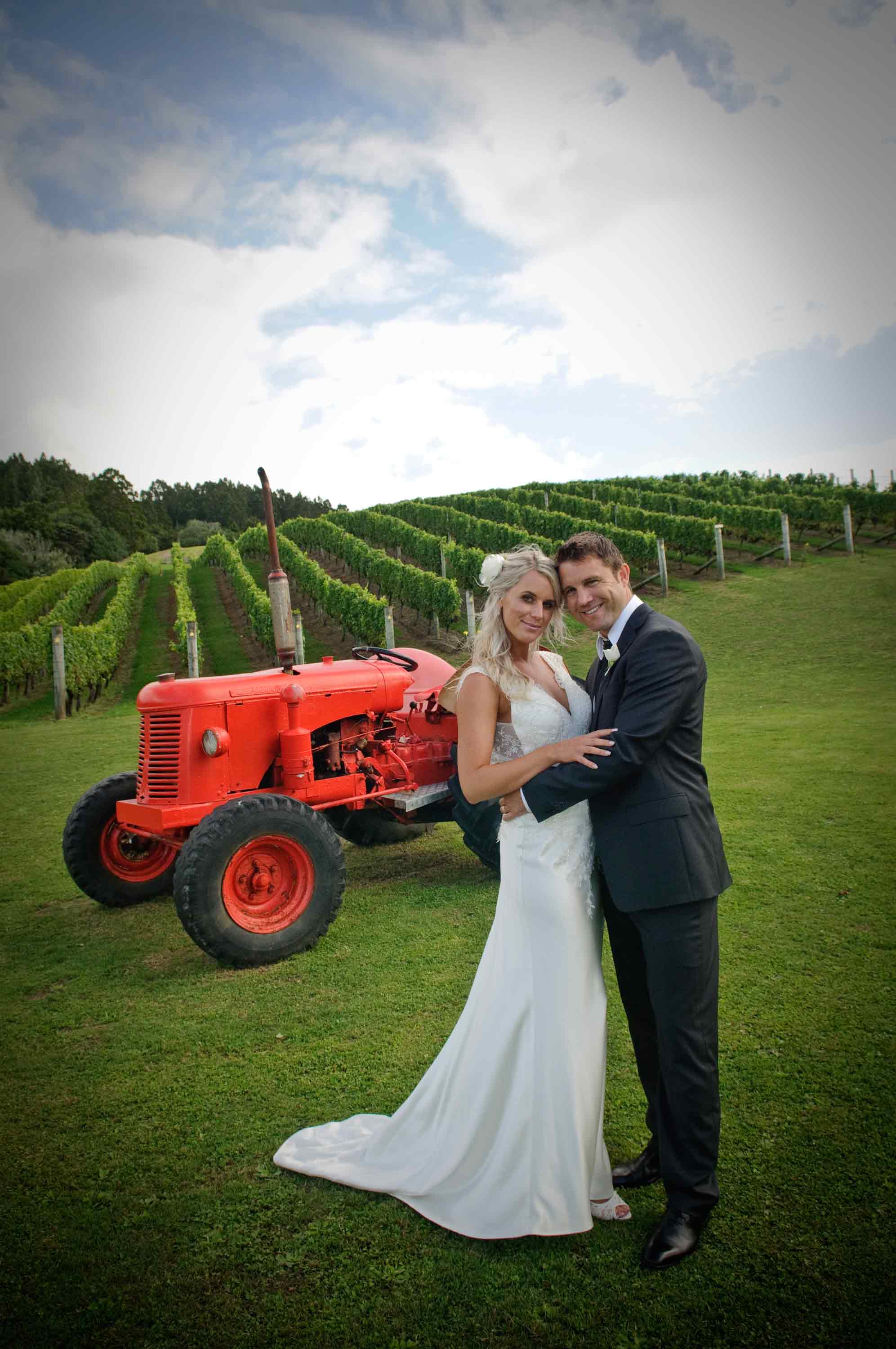 Bridal-couple-with-little-red-tractor