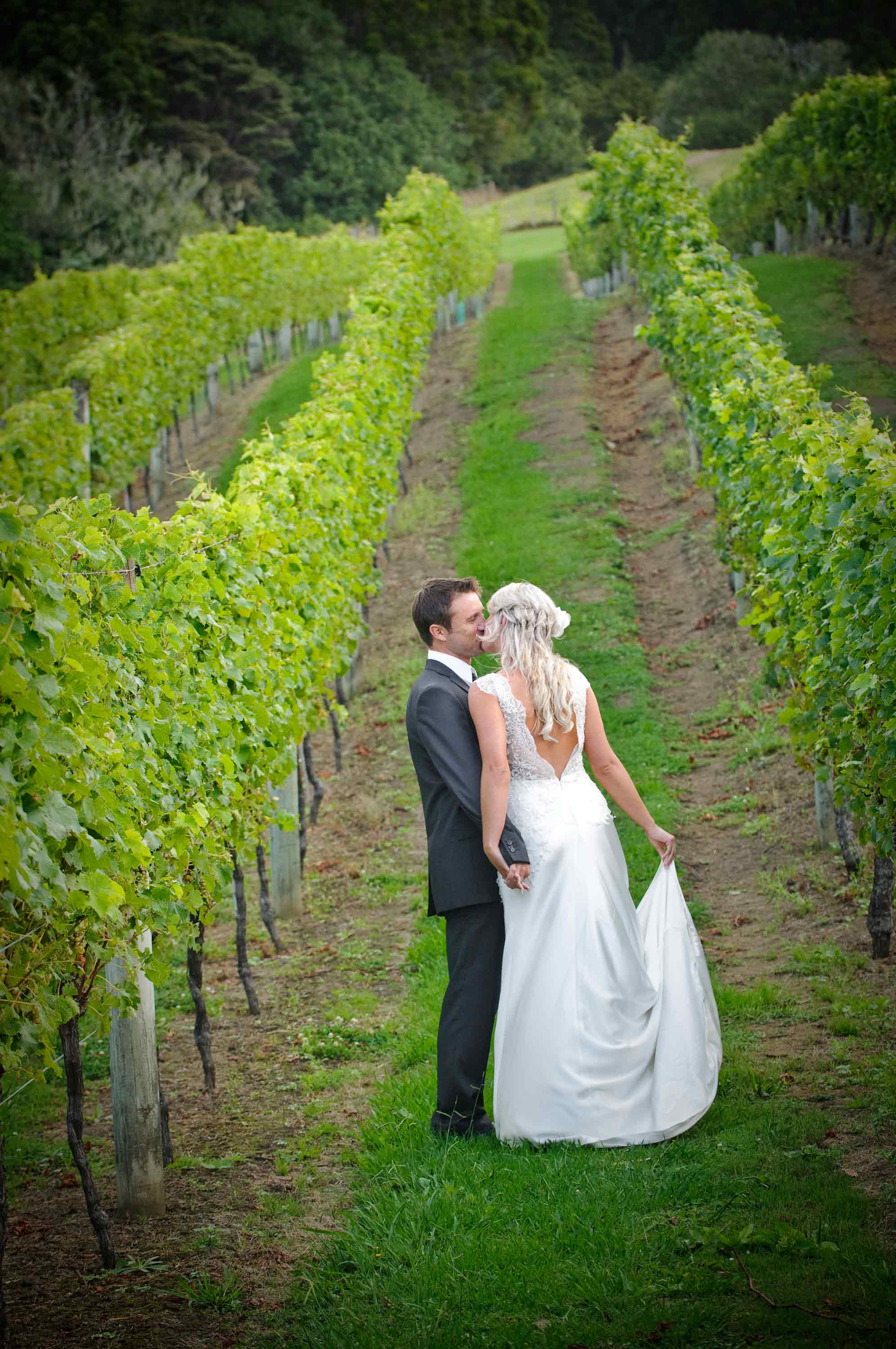 Bride-and-groom-embracing-in-the-vines