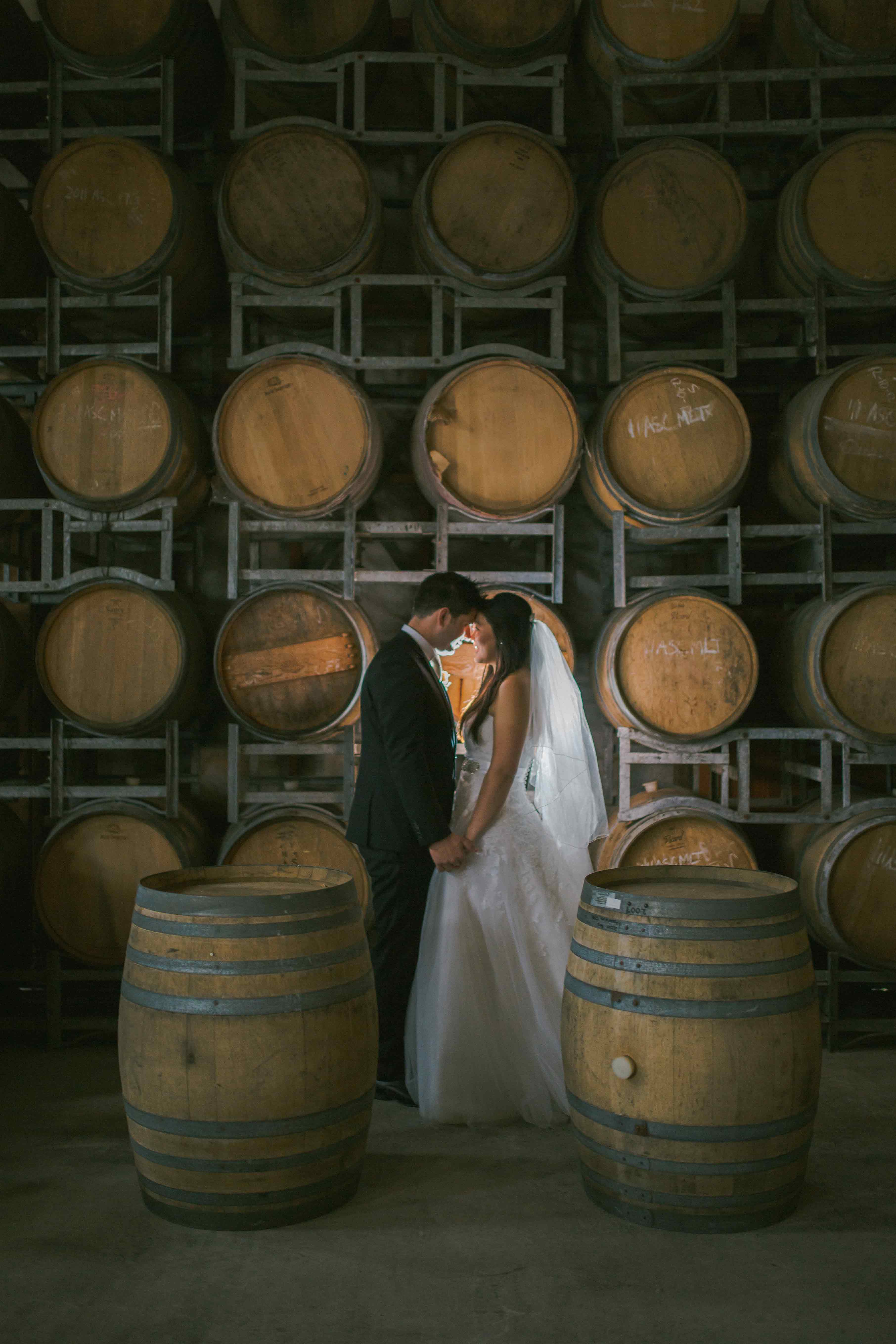 bridal-couple-with-barrel-wall