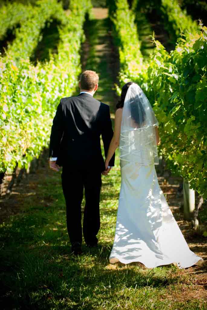 bride-and-groom-walking-in-vines
